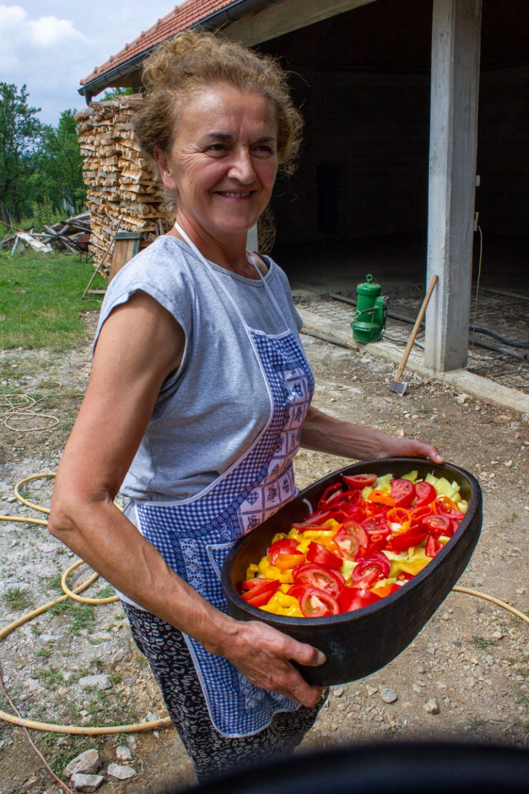 a woman chef holding a dish