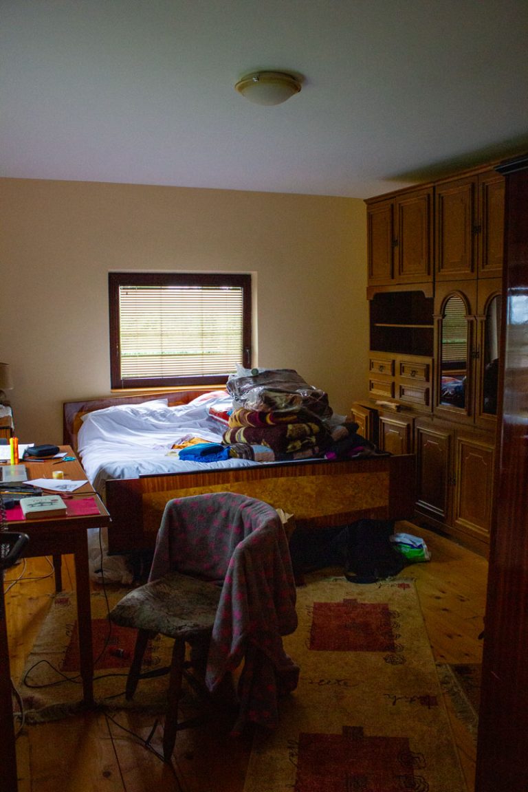 a bedroom with bed and cabinet