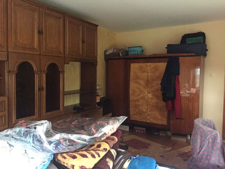 a bedroom with belongings and closets