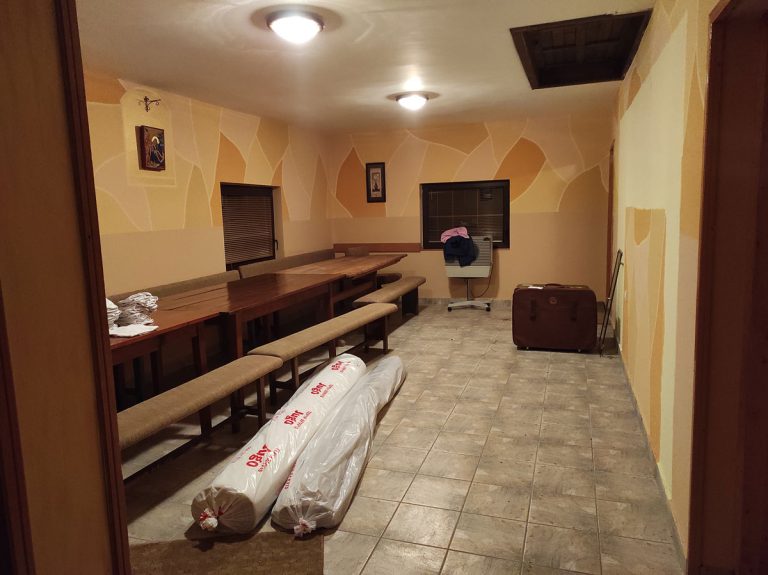 empty slava room with dining tables and rolled rugs