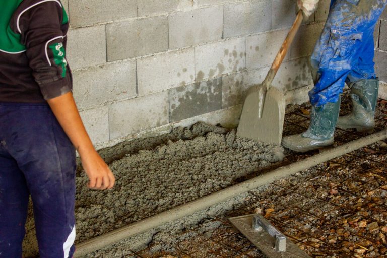 workers pouring concrete in a garage