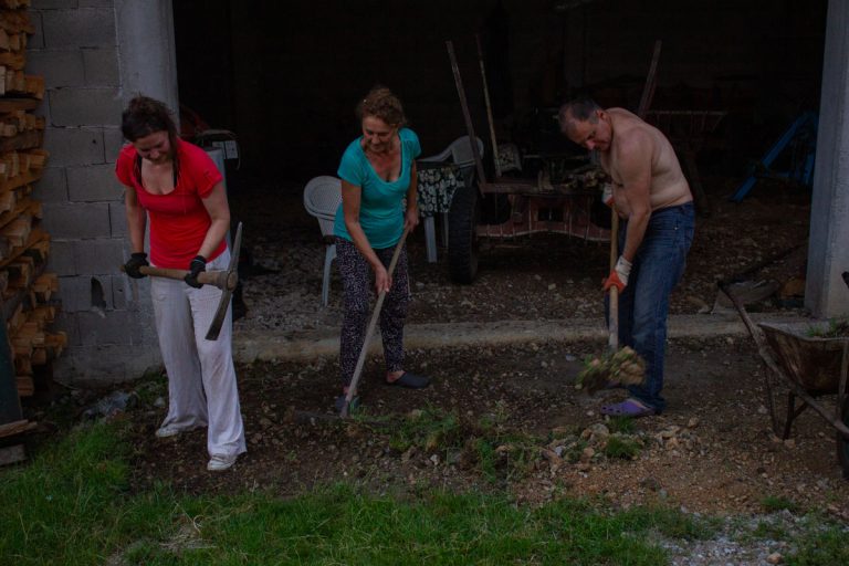a man and women working in front of a garafe