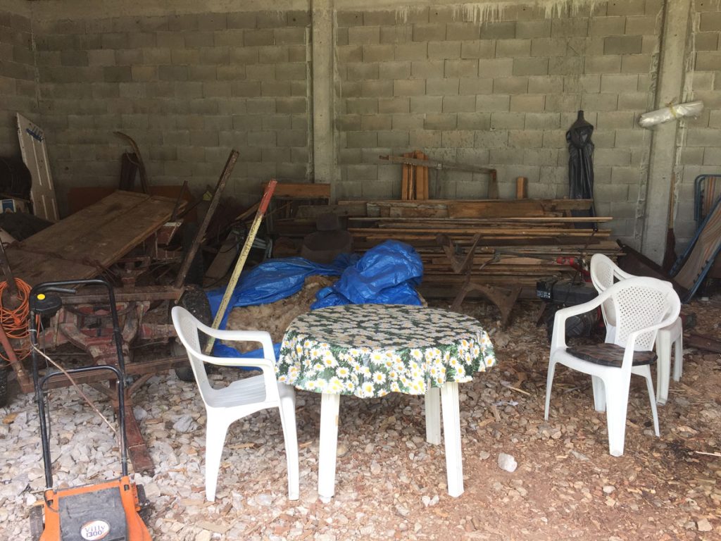a garage interior with a chair and a teble