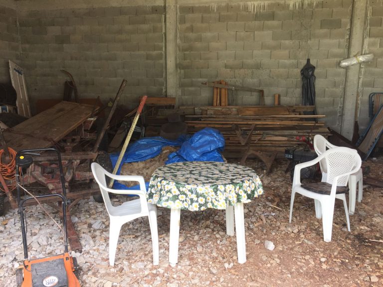 a garage interior with a chair and a teble