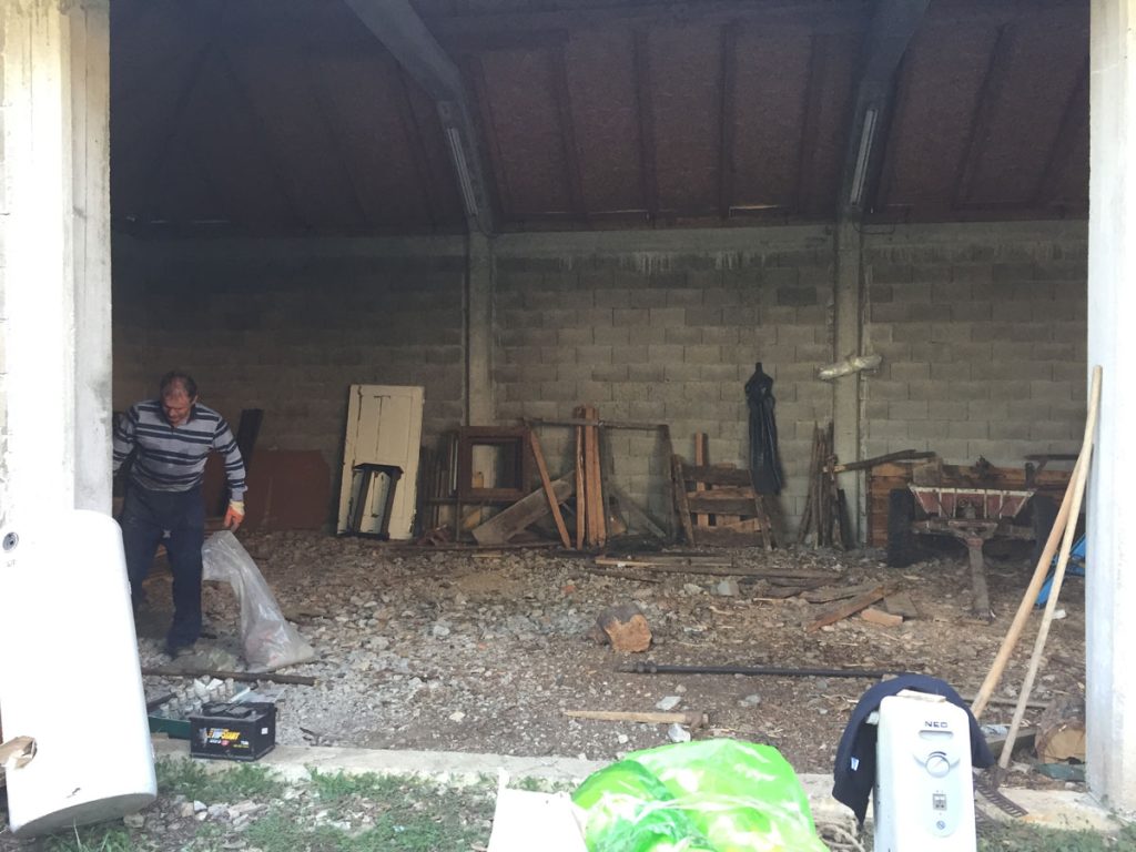 a man moving stuff around in a garage