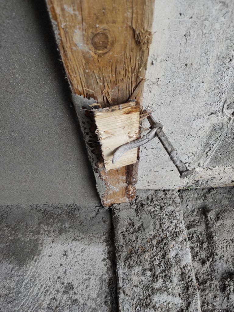 a detail of a mason peg during mortaring the wall