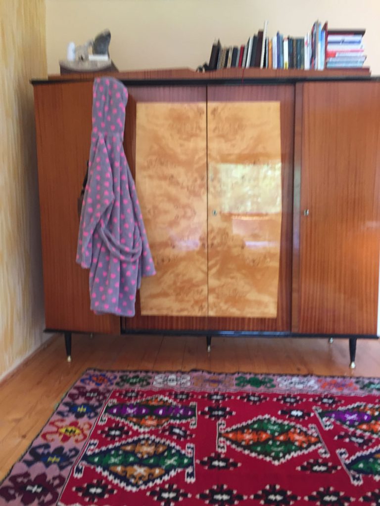 an old classic wardrobe and traditional kilim