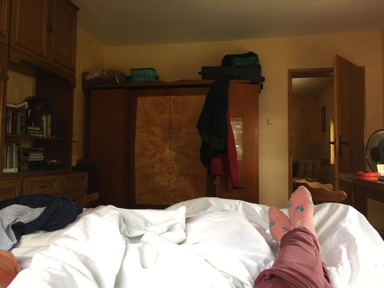 a pov of a bedroom with a wardrobe and cabinet