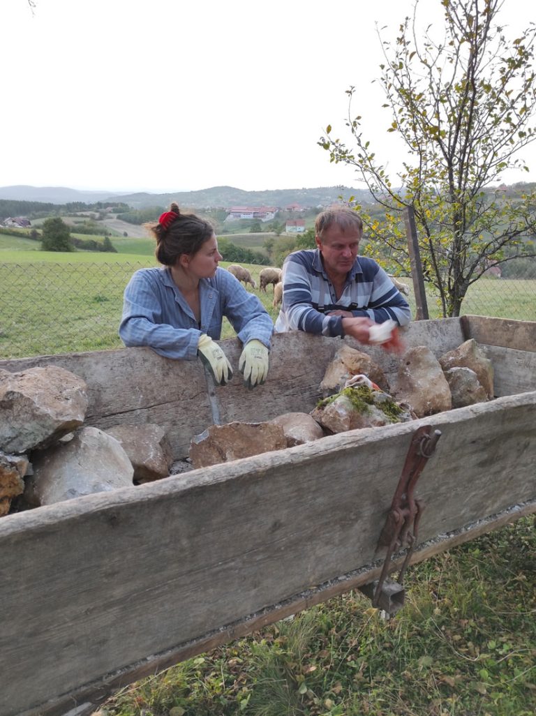 a girl and a man discussing the stone wall