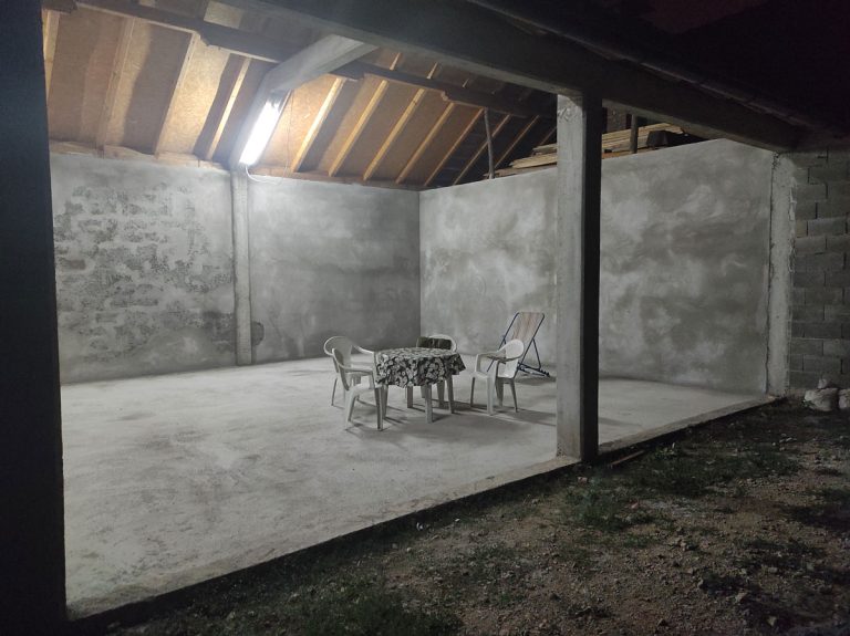 an evening garage interior with table and chairs