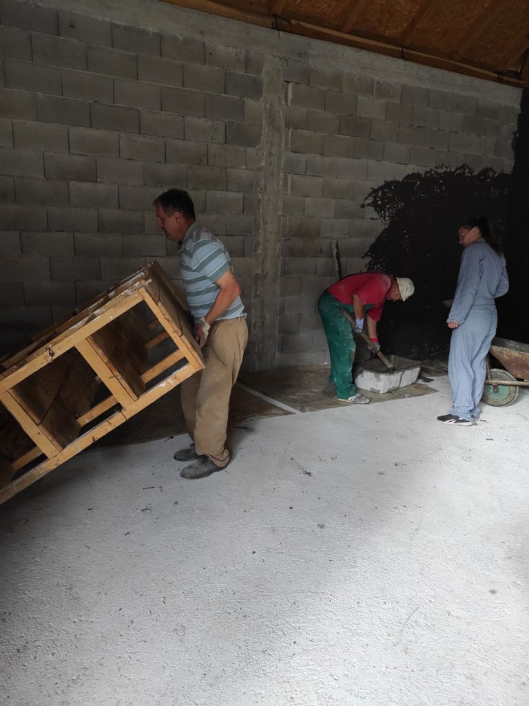 workers mortaring the garage wall