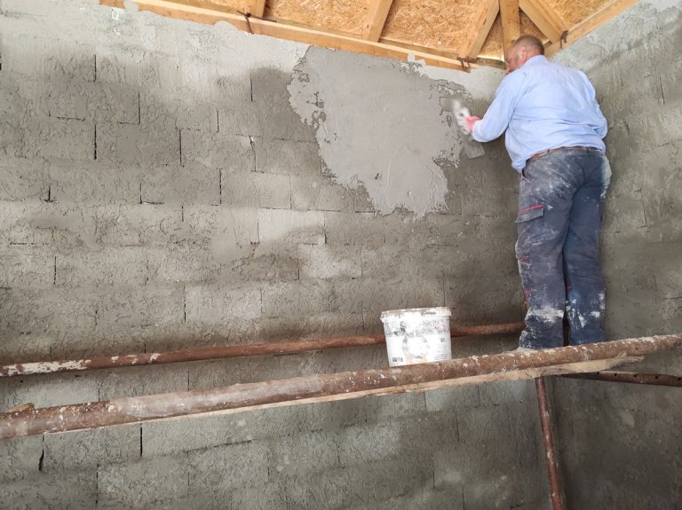 a worker mortaring the wall