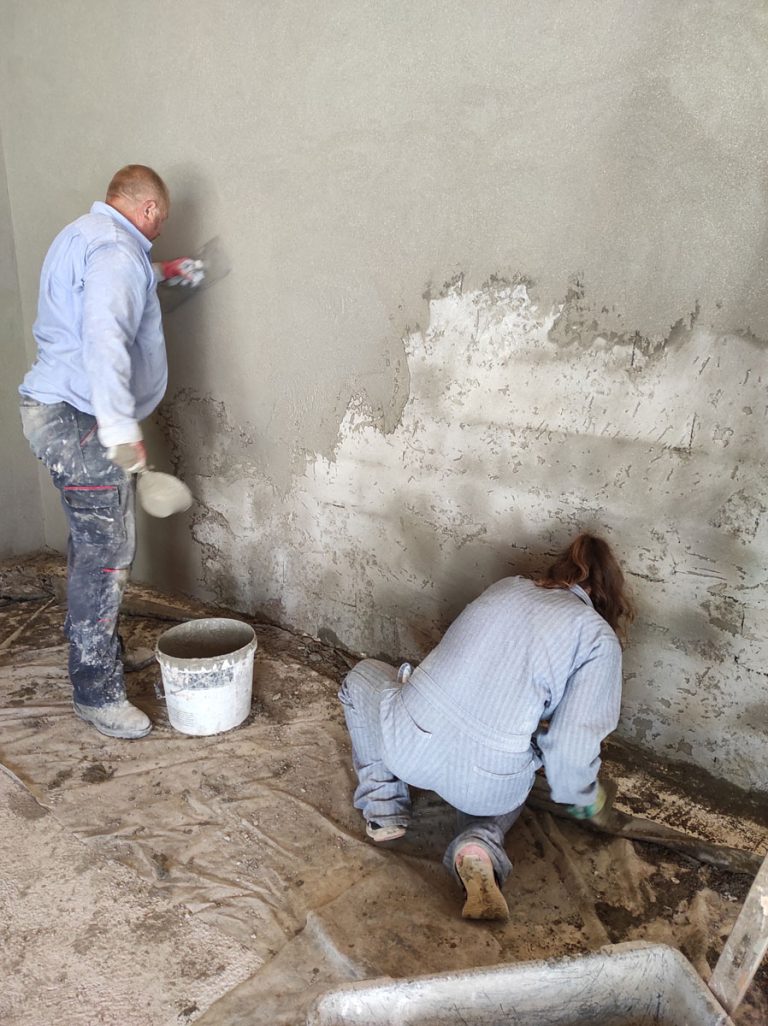 workers mortaring a wall