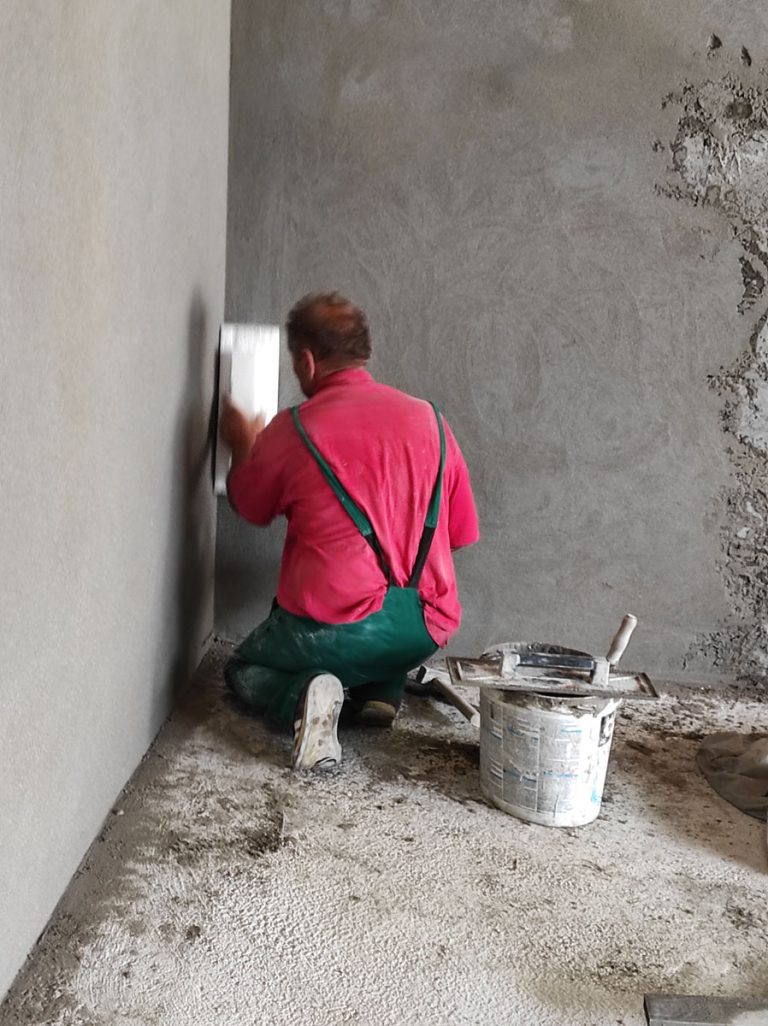 a worker mortaring the wall
