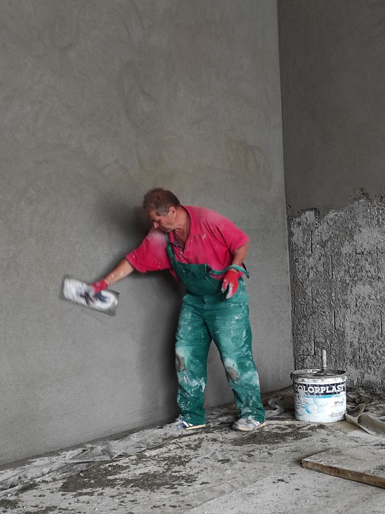 a worker mortaring the wall