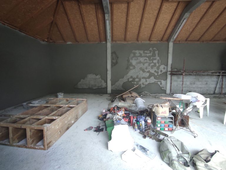 garage interior with mortared walls and belongings