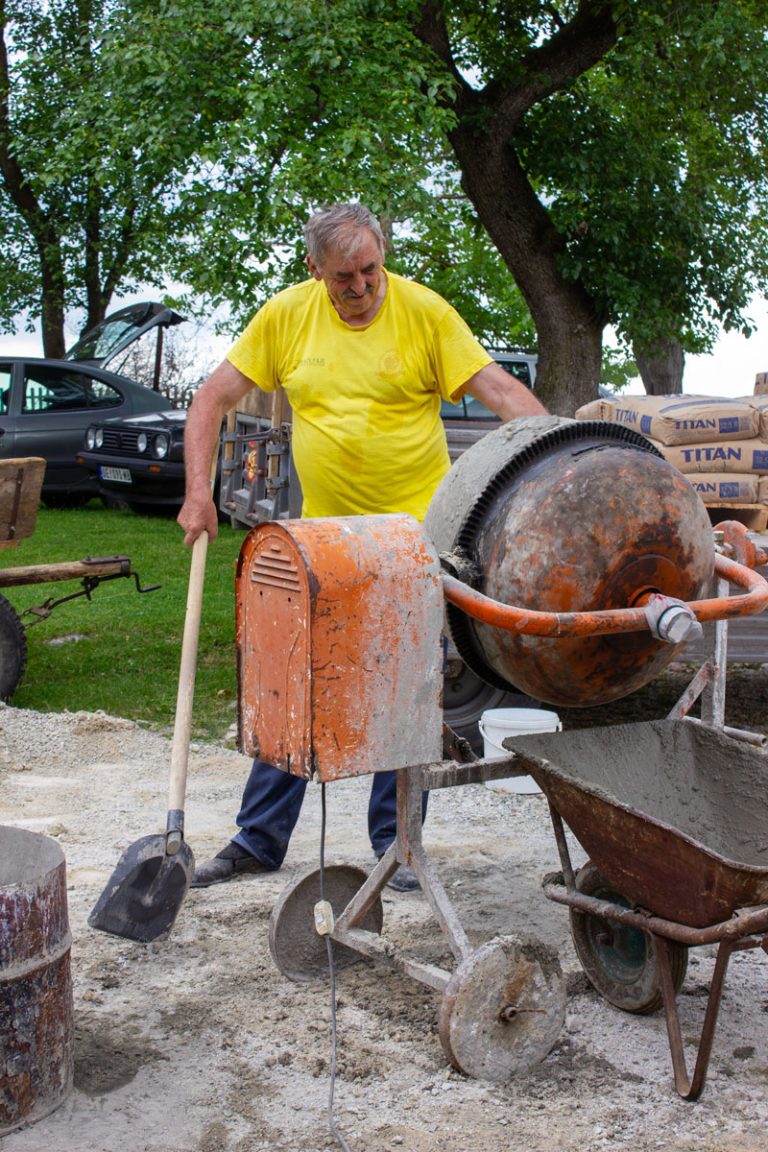 a wrorker mixing concrete