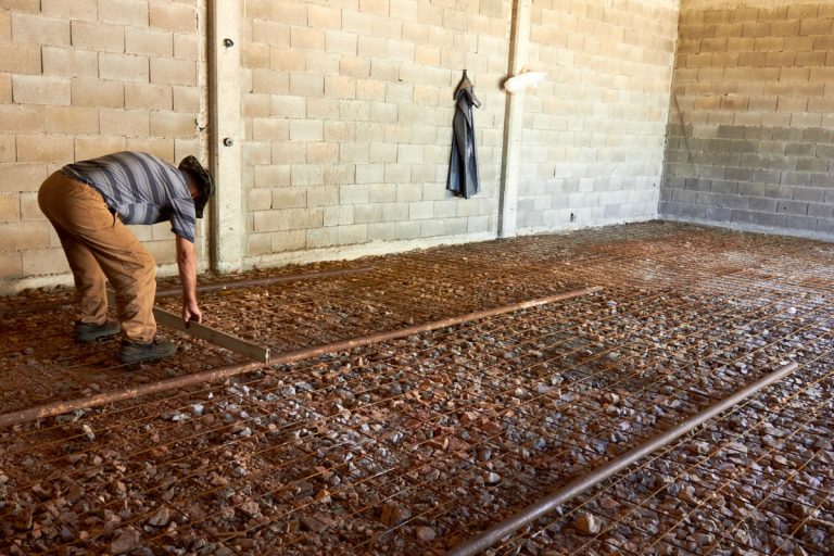 a worker leveling a formwork in a garage