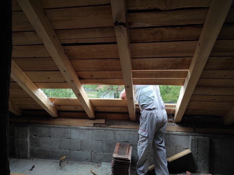 a worker reconstructing a roof