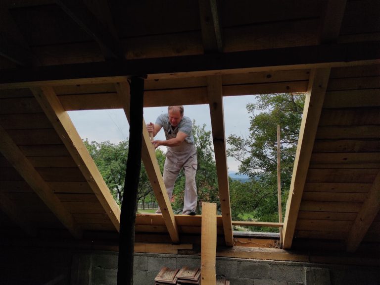 a worker reconstructing a roof
