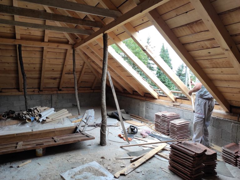 a worker reconstructing a roof