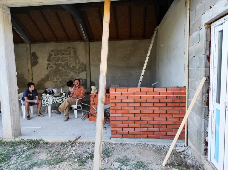 workers taking a break during a brick wall building