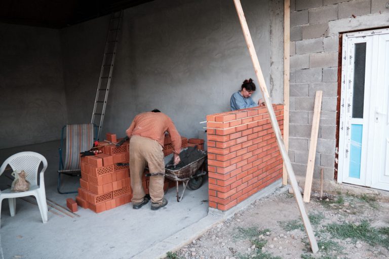 workers building a brick wall