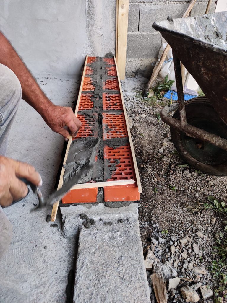a worker building a brick wall