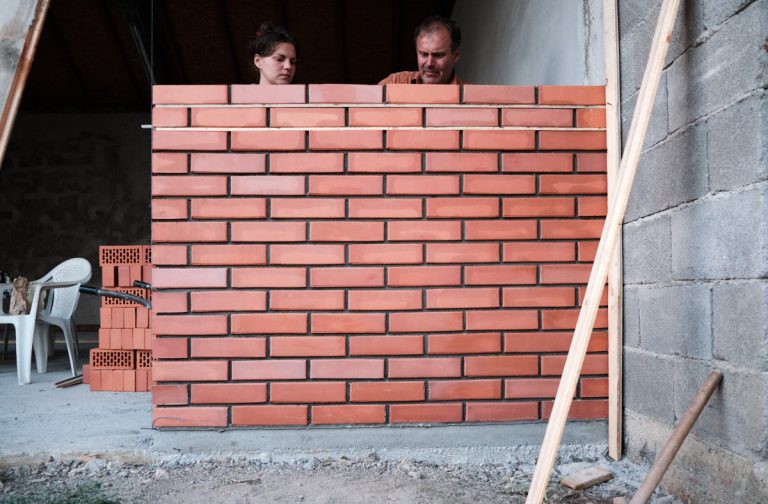 workers building a brick wall