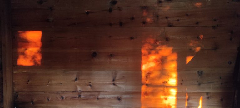 an old wooden cottage interior with sunset lights