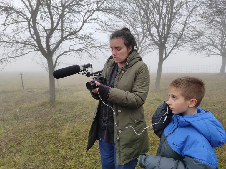 a woman and a boy filming