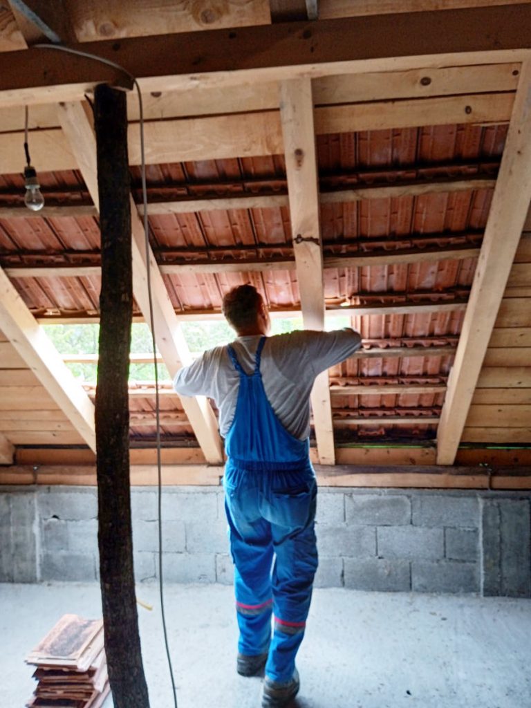 a worker reconstructing a roof