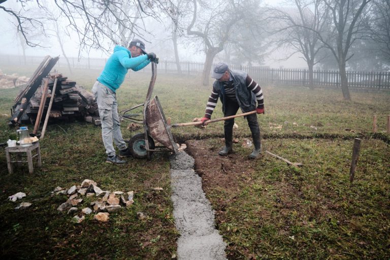 workers building a cottage foundation
