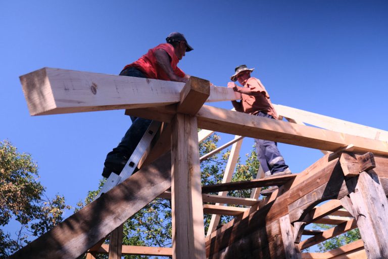 workers building a new roof construction