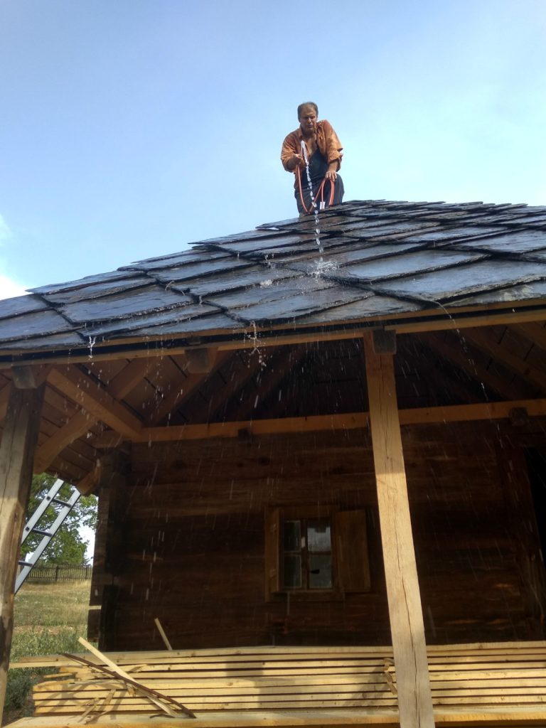 a worker trying to wet new slate tiles