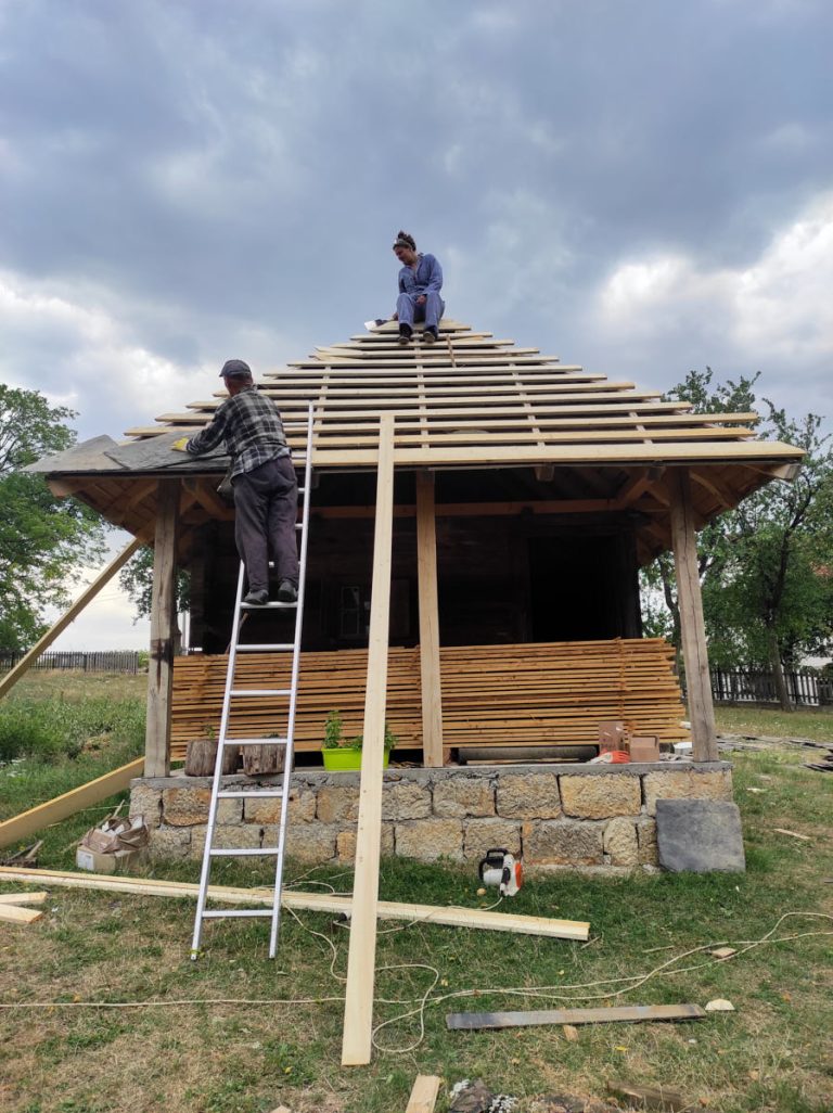 workers building new roof tiles