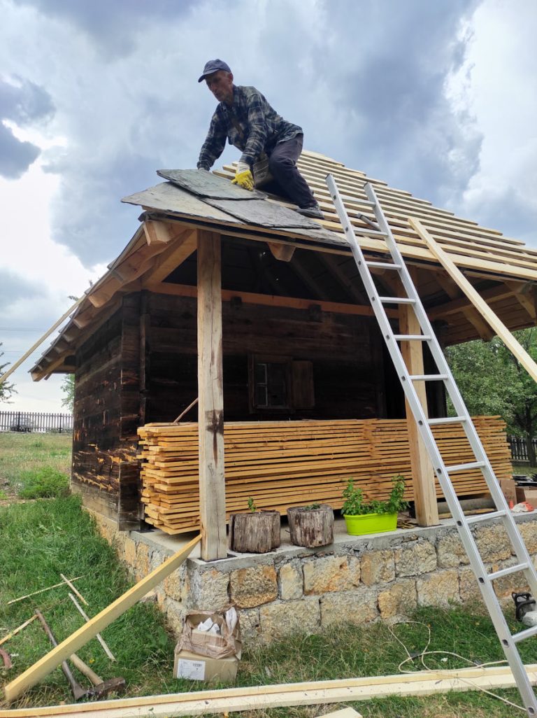 a worker building new roof tiles