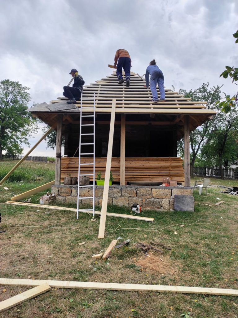 workers building new roof tiles