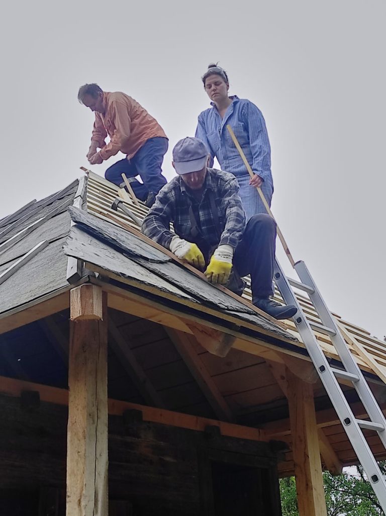 workers building new roof tiles