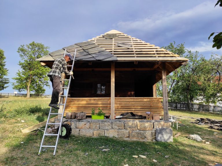 a worker building new roof tiles