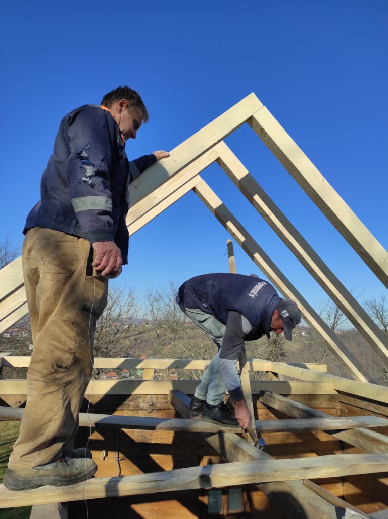 workers building a new roof construction