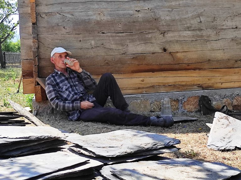 a worker on a break drinking water in a shade