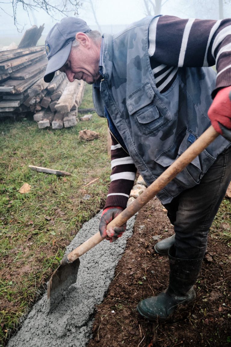 a worker building a cottage foundation