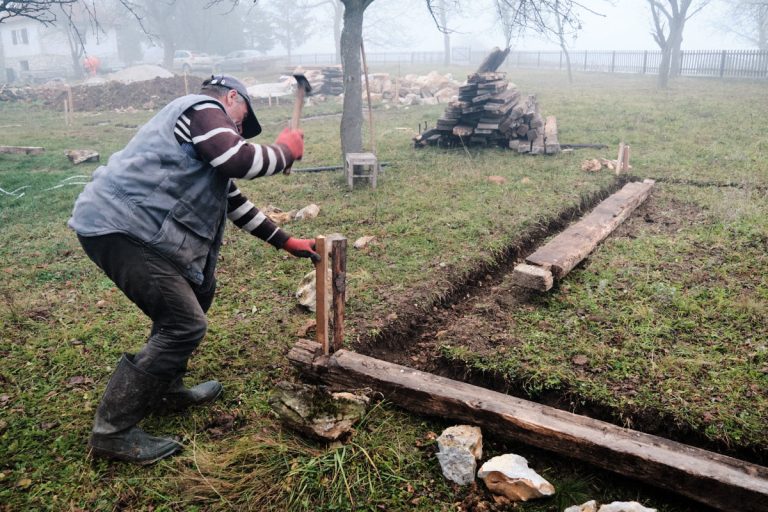 a worker building a cottage foundation