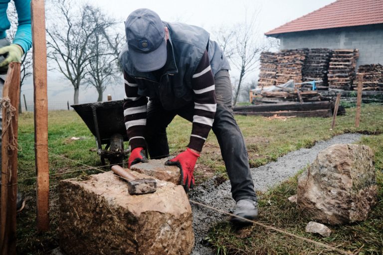 a worker building a cottage foundation