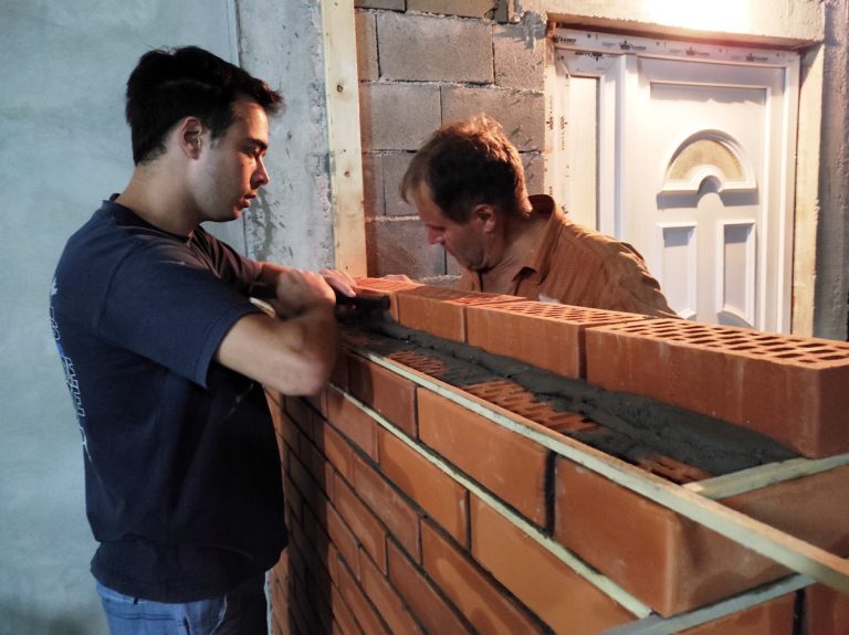 workers building a brick wall