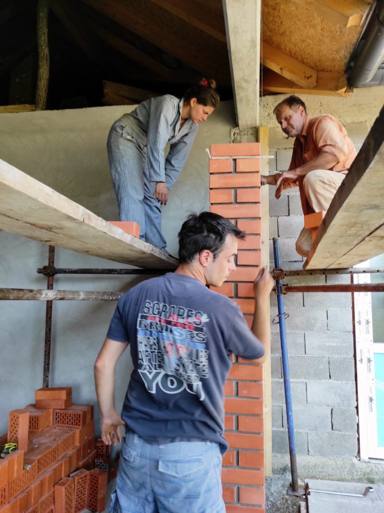 workers building a brick wall