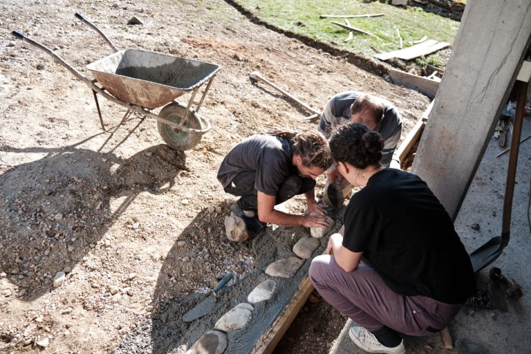 workers building a cobblestone pavement