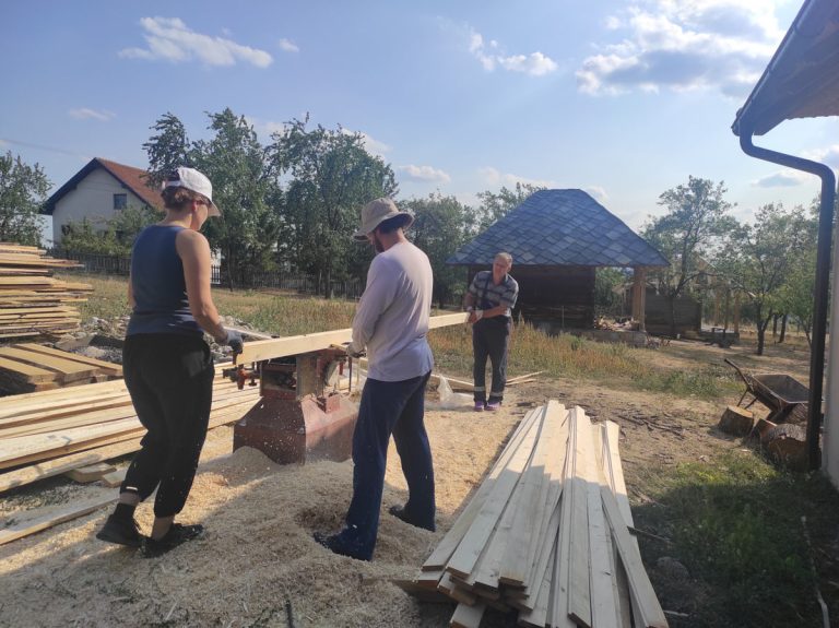 workers planing a wood beam