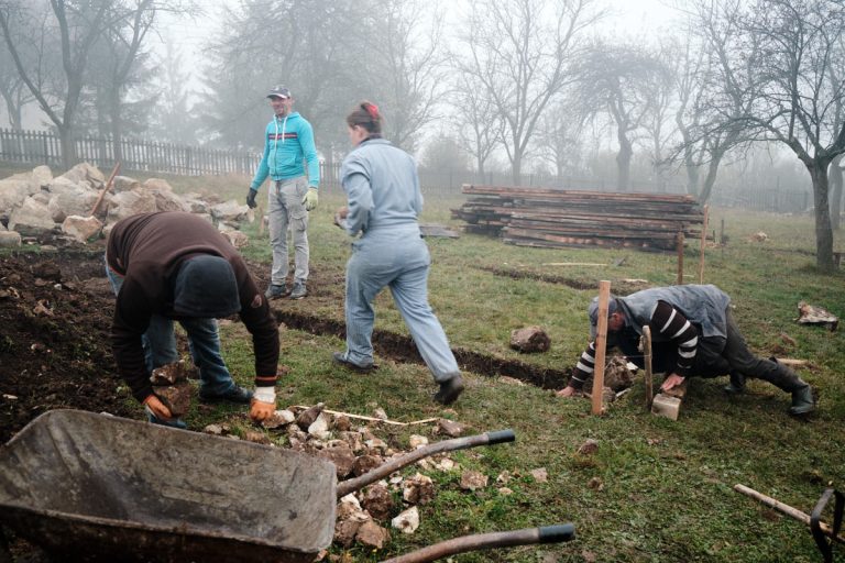 workers building a cottage foundation